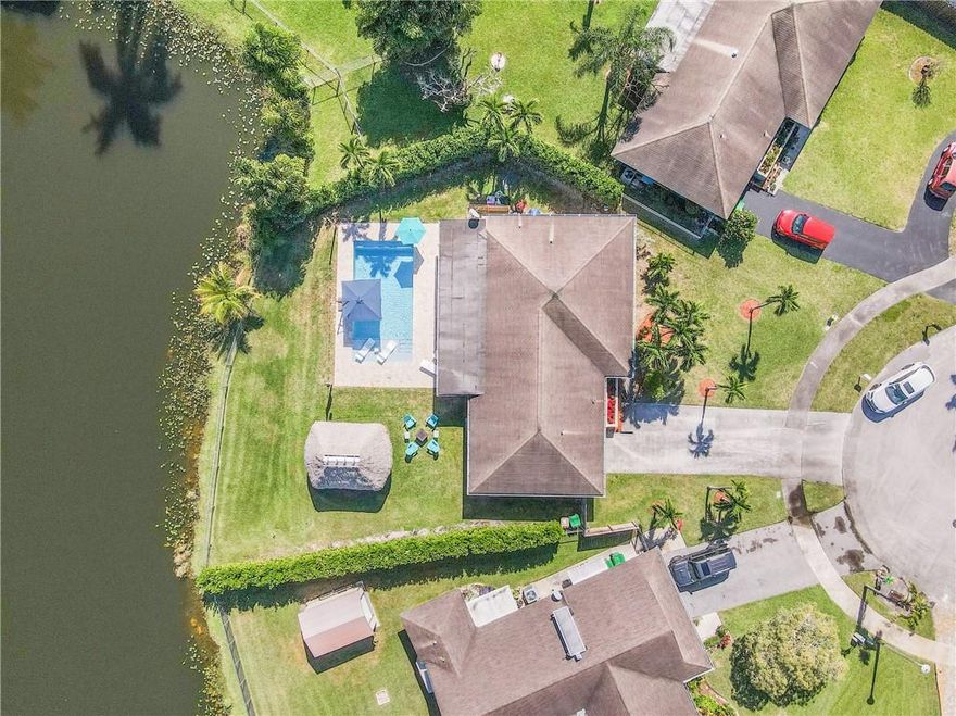 WOW FACTOR! Welcome to this updated lakefront home, located on a quiet cul de sac in desirable Orange Tree Lakes. The back yard is serene and perfect for entertaining. Modern saltwater pool w/ luxurious sun-shelf and expansive travertine patio (new 2021). Covered patio feat. Brazilian hard wood ceilings, recessed lighting, fans, custom TV wall, and outdoor shower. Tiki hut w/ synthetic turf. FULL IMPACT windows, impact doors and sliders. Primary bedroom w/ lake view, ensuite renovated (2021) cabana bath, and walk-in closet. Guest bath reno 2022. Large indoor laundry (W&D 2022). New AC 2022. New 2022 SS appliances. Bonus room great for office or playroom. Living room w vaulted ceilings and built in surround sound. Control 4 home automation system. NO HOA and great schools!