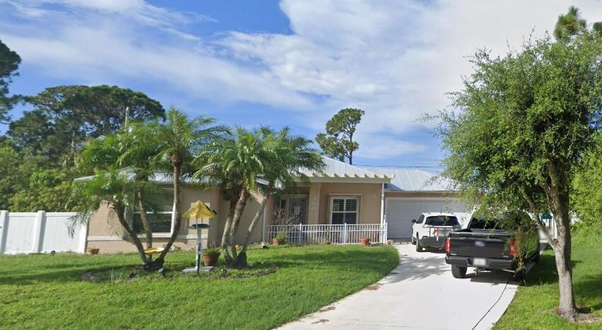 CBS Home with accordion hurricane shutters and metal roof. Great location close to shopping and turnpike as well as I-95.
