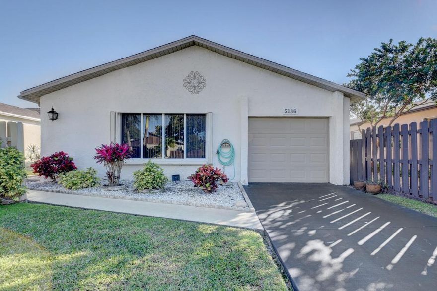 Priced to SELL! Waterfront 2BR 2BA w/ garage & lovely impact glass-enclosed FL room in very popular Boynton Beach  55+ HOPA community. Numerous improvements include wooden cabinets/granite counters and updated lighting in kitchen and both baths. Poured concrete driveway, pull down ladder for access to plenty of attic storage space.  Charming community is gated, w/ just 238 homes, & features tree lined streets, plenty of green spaces, waterfront walking promenades, lakefront pool, tennis/pickleball, boat ramp and more. LOW HOA fee includes lot irrigation, cable/internet. Very well located to 3 Int'l airports, highways, houses of worship, BEACH and walkable to shopping, restaurants. Come see today!