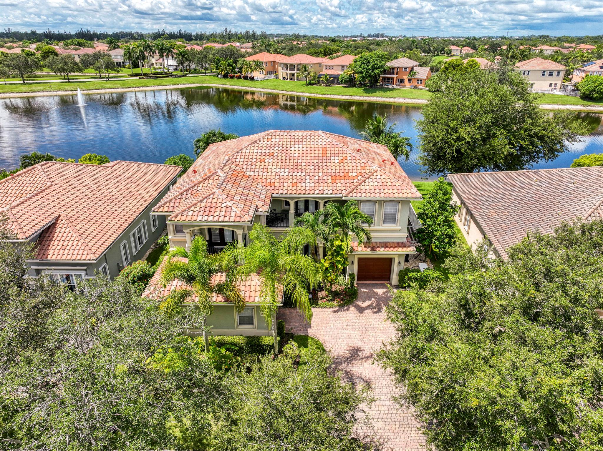 Welcome to Terracina - a highly desirable single family home community centrally located in West Palm Beach. This one of a kind Mediterranean style home offers a diverse & expansive layout with endless opportunities. This ''Giacosa'' model features 5 bedrooms, 4 full bathrooms, 3393 living sqft, additional private den/office situated in the primary suite and two exterior balconies. Enjoy the comfort of your own private pool with direct lakeviews and recently installed screened-in pool cage. In addition, you will find a full summer kitchenette with granite countertops, built-in grill, cooking burners and attached refrigerator. The multi-level floorplan offers formal dining, a living area, family room, large kitchen with eat-in area and a bedroom on the ground floor. The second level feature