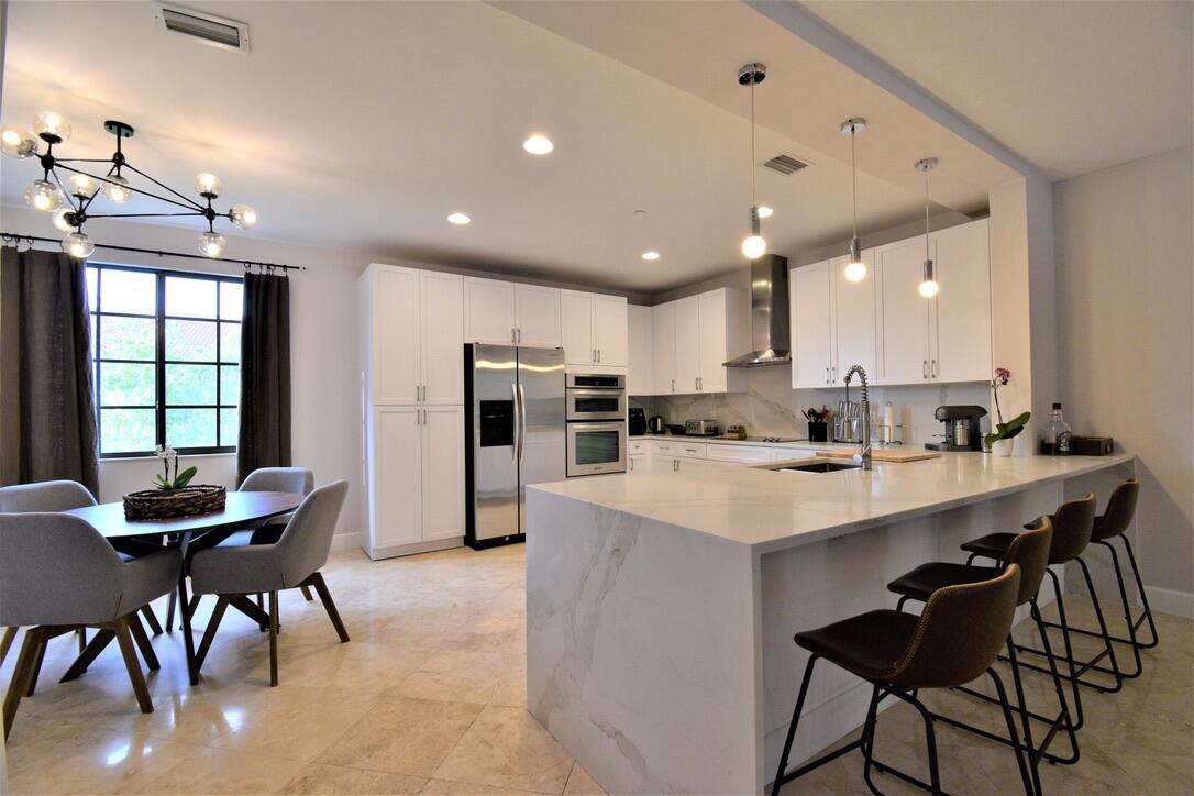 Remodeled in a exclusive design. unfurnished. This property is bigger than the usual Centra units. Beautiful 3 Store townhome with Privite Elevator, Impact Hurricane glass throughout, in prestigious Centra Community in the heart of Boca Raton. Great Schools, good for people who love walking around the lake & access to Spanish River Park & Public Library. On The First Floor has Spacious 2 car garage + privacy suite with full bath and walking closet in travertine marble flooring. Stunning open great room with open balcony on 2nd floor all integrated kitchen with waterfall island in Calacatta Gold. Half bath and dining room area. Wood flooring throughout on 3rd floor, with Master Suite with sitting area, huge walking closet, stunning and unique Master Bath with 2 waterfall shower .