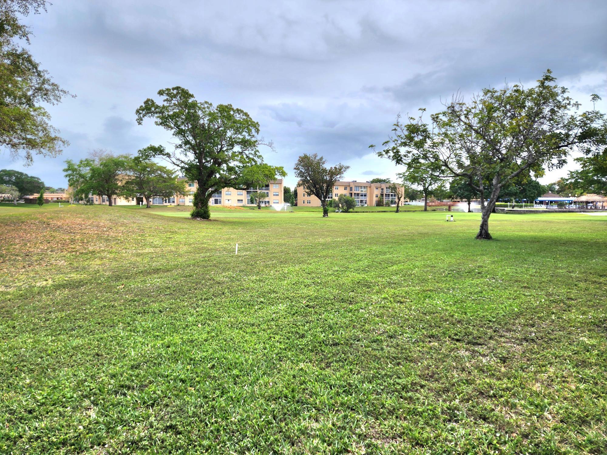 PRICE IMPROVEMENT--1st floor-2-bed, 2-bath unit in a well-maintained 55+ community. This quiet retreat has a golf course view and comes fully furnished (excluding personal items) with tile and carpet throughout. Enjoy resort-style amenities, including golf, heated pools, tennis, shuffleboard, a clubhouse, a theater, a gym, and more. Roll-down shutters on the patio. No rentals allowed. Financing requires 20% down, cash 10%, income requirements for a 2/2, $3,000. All buyers must be 55+, with a 6-month escrow maintenance deposit held for two years. Seller will pay roof assessment in full prior/at closing. See MLS for attachments. Unit is sold "AS IS" with right to inspection.