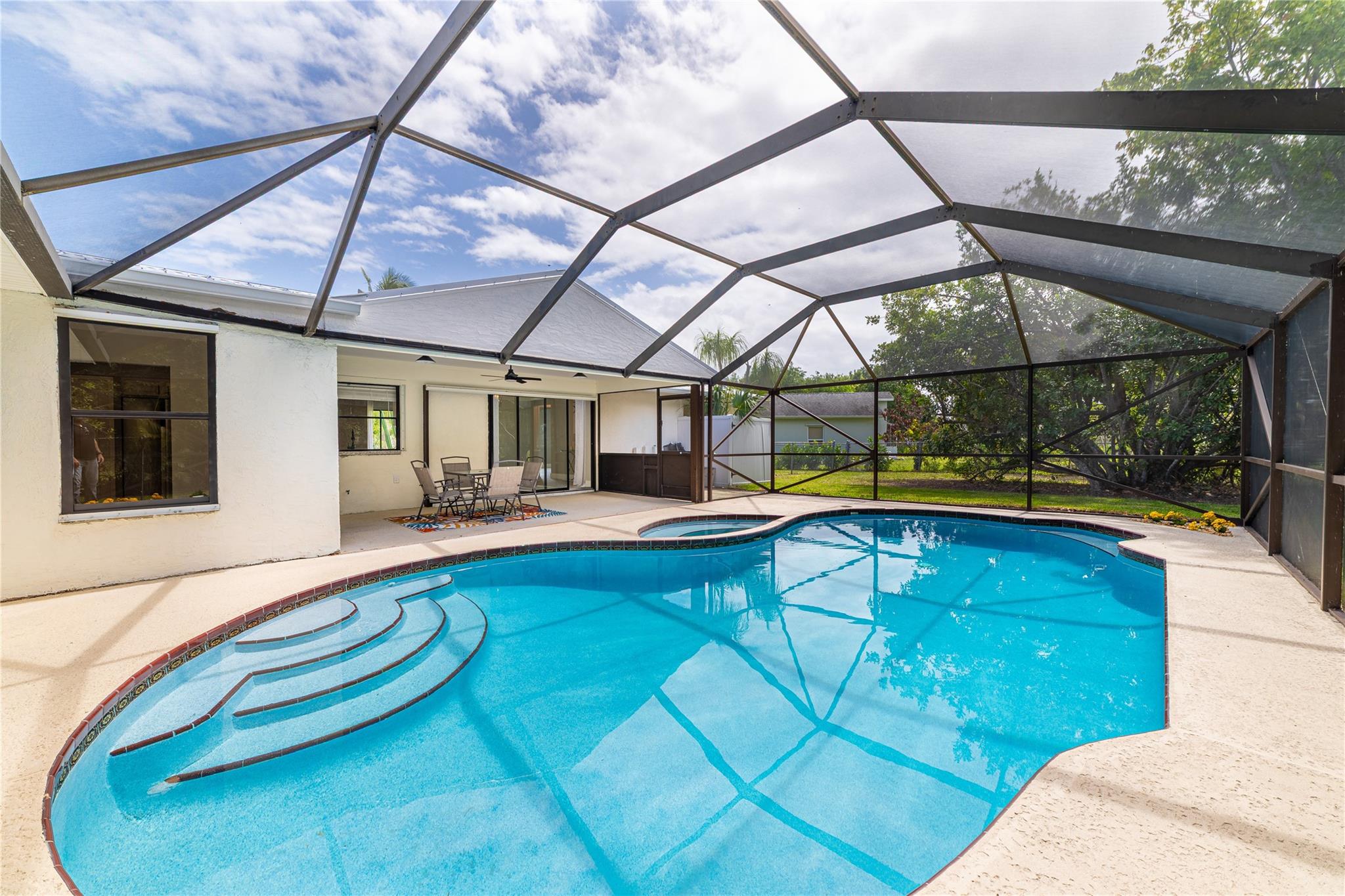 Check out the NEWs! This modern gorgeously updated 3-bedroom, 2-bath pool home, 2-car garage, plus FLEX ROOM plus DEN - in East Port St. Lucie has it all, with no HOA in a great location!
• NEW roof (2023)
• NEW pool screen
• NEW pool pump
• NEW gutters
• Beautiful upgraded shed
• Newly painted garage
• NEW luxury vinyl plank flooring
• NEW appliances, NEW grill, and a fireplace
• NEW interior & exterior paint
• NEW dimmable chandeliers in multiple areas + dimmable lighting in the kitchen
• NEW AC thermostat
• NEW flex room with walk-in closet & windows—perfect for a guest space, office, or playroom (buyer to verify)
• Den—ideal for a formal dining room or office
• Bonus nook space with pool views—great as a breakfast area or light-filled gym corner.