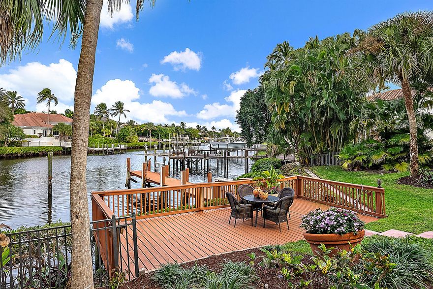 Nestled in the prestigious Admirals Cove community, this exceptional residence offers a blend of luxury and tropical charm. Step into a beautifully designed courtyard that welcomes you with warmth and elegance, leading to a spacious guest house perfect for visitors or extended stays. The home boasts a large kitchen ideal for entertaining, while the expansive living areas open to a breathtaking long waterway view that captures the essence of waterfront living. Enjoy the ultimate in outdoor relaxation at your private tiki bar, surrounded by lush landscaping that ensures complete privacy and serenity. With four car garages providing ample space for vehicles and storage, this property combines functionality with refined style in one of Jupiter's most sought-after neighborhoods.
