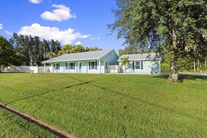 Welcome to a home that blends Florida charm with thoughtful upgrades and a ranch-style retreat set on a rare 0.57-acre double lot with, Hardie board siding, and a metal roof, this home was designed for both energy efficiency and lasting quality.Step inside to vaulted ceilings and a bright, open floor plan. Tile flows throughout the main living spaces, and primary bedroom, while two guest bedrooms feature carpet. The kitchen offers dark wood cabinetry, granite countertops, a breakfast bar with seating for three, and stainless Samsung appliances perfectly designed for cooking, entertaining, or gathering with family.
