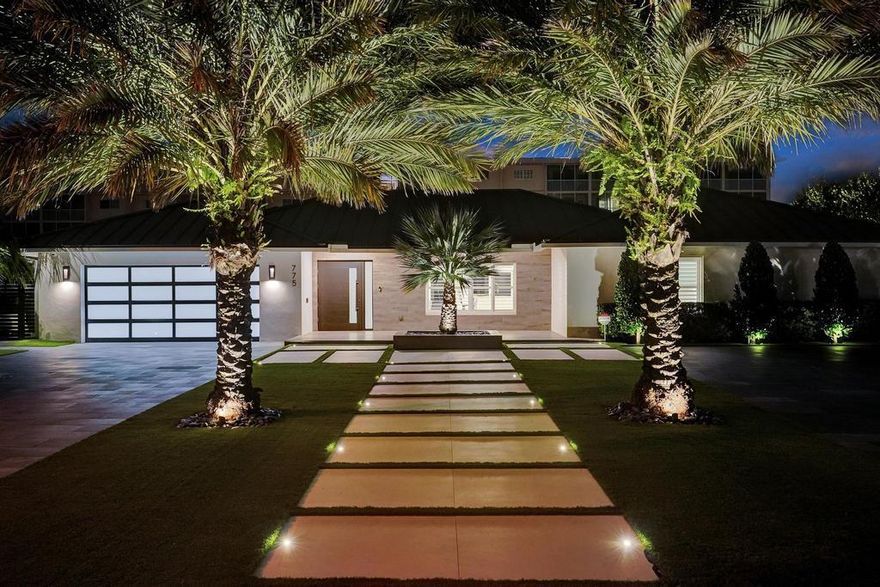 Situated on a private peninsula in the prestigious Lake Rogers neighborhood, this refined waterfront home has all the bells & whistles. A dramatic entrance flanked by Medjool Date Palms features Italian porcelain driveways. High-end landscape & lighting all on smart controls. Expansive loggia leads to 50' saltwater lap pool w/sunshelf & spa. Outdoor kitchen w/Lapitec waterfall countertop. New 94' of seawall cap overpour plus (9)x12''x20' pre-stressed concrete dock piles & new 4'x75' concrete dock. A quick boat ride to Boca Inlet, a true boaters dream. Entire home has new plumbing, natural gas tankless water heater, Toto wall hung toilets, high-end plumbing fixtures, Wolf/SubZero appliances, Calcutta Gold quartz, whole house generator...much more listed on feature sheet! It's perfection!