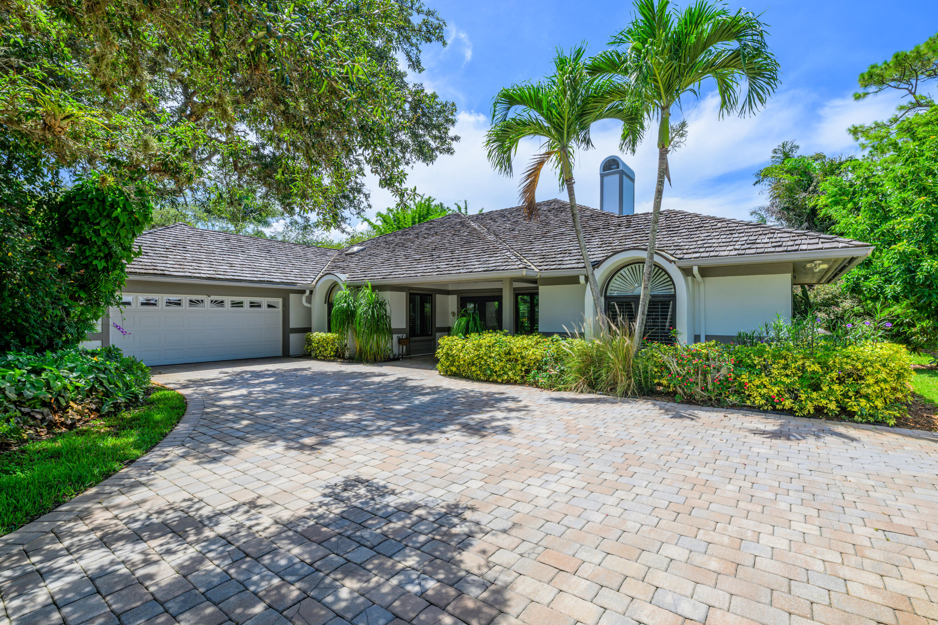Welcome to River Landing -- Palm City's Hidden Gem! Discover a rare opportunity in one of Palm City's most sought-after gated communities. Nestled along the scenic St. Lucie River, River Landing is a pet-friendly, boating neighborhood that combines natural beauty with exceptional amenities. Enjoy ocean access via a private boat ramp, a day dock, boat storage, two tennis courts, a pickleball court, and a playground--all with remarkably low HOA fees of just $485 per quarter. As you enter the home, you're immediately drawn to the uninterrupted lake views framed by French doors that open from the main living area, filling the space with light and a sense of openness. This traditional Southwestern-style retreat features a spacious living room with vaulted ceilings and