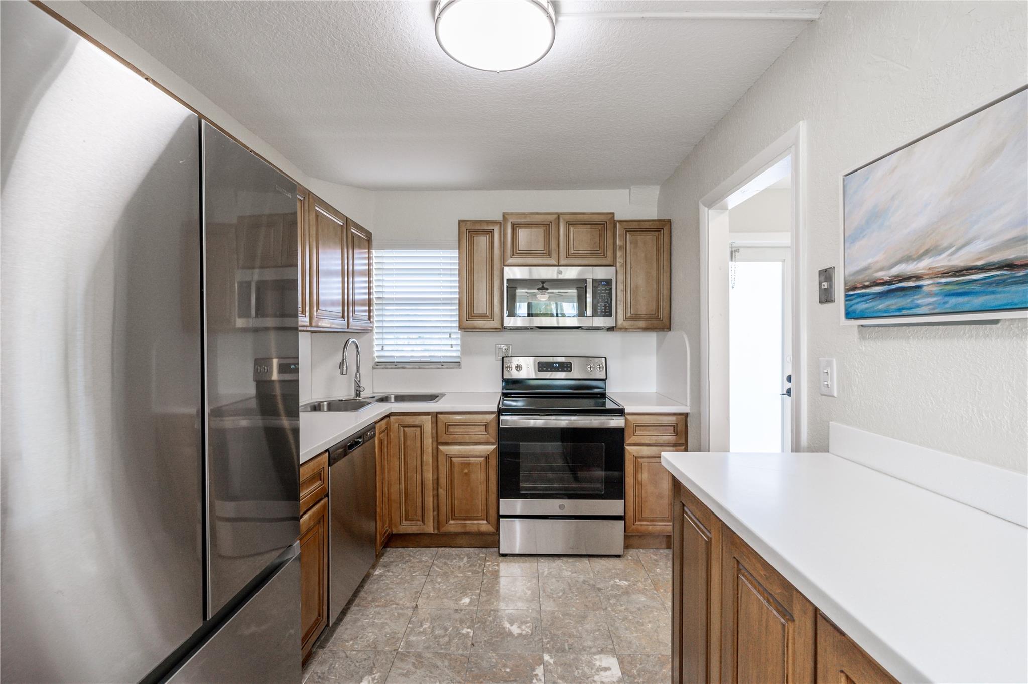 GOLFER'S DELIGHT! 4th FLOOR PANORAMIC PGA GOLF VIEW! 1BR/1.5BA featuring open tiled kitchen w/maple cabinetry, SS appliances & waterproof vinyl plank flooring. IMPACT windows & front door. Newer AC. New vanities in bathrooms w/ designer knock-down walls. Attractive laminate oak flooring. Updated shower in master bathroom. Enclosed balcony blocks all noise. Recreation Lease PAID IN FULL! FREE golf (except cart fees) on two 18 hole courses (PGA & Par3); Amenities include Restaurant, Billiard Room, Bbq/Picnic Area, Clubhouse, Courtesy Bus, Exercise Room, Heated Pool, Library, Putting Green, Sauna, Shuffleboard, Tennis, Pickle Ball, Vehicle Wash Area, Electric Car Charging Station. Close to shops, dining & highways. 15 min. to the beach. Association says 55+ age required; EXCELLENT!