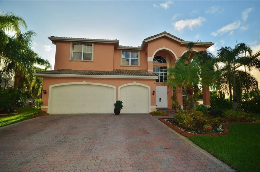 Wow!! Enter this expansive 5 bedrooms+ 6th for den or bedroom, full bath nearby, & 2 full sized master suites, with endless possibilities! From the gorgeous REAL WOOD flooring throughout, stunning totally renovated kitchen, with virtually every possible feature, upgraded baths & a grand wrought iron staircase.  Custom closets in most bedrooms, recessed lighting, & epoxy garage floor, are only a few features. Travertine Patio & inviting pool & huge yard, & even accordion shutters! Guard gated & Rec Center