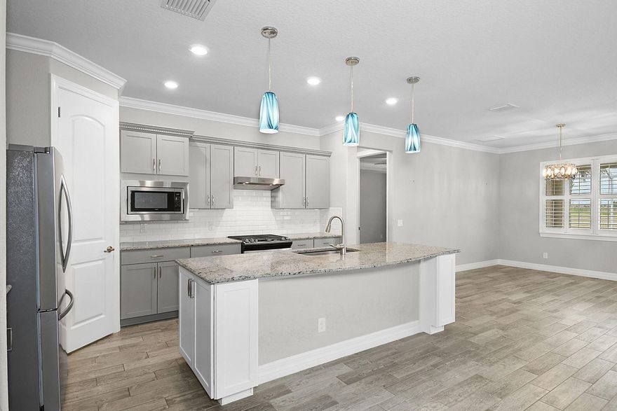 ***SELLER PAYING OFF THE NEXT 18 YEARS OF THE CDD*** New owner will not have one!! Experience the best of 55+ resort-style living in this beautifully designed and very spacious 2-bedroom PLUS den, 2-bath POOL home in the sought-after Del Webb at TRADITION community. This modern residence offers an open and airy floor plan with upgraded finishes, full impact glass windows, volume ceilings throughout, oversized laundry room with upgraded cabinetry, and a covered, screened patio that overlooks a sparkling saltwater pool--set on a preserve, perfect for entertaining or relaxing year-round. The oversized open-concept home features plantation shutters, crown molding, upgraded baseboards, custom built-ins, upgraded countertops and an upgraded extended shower in the owners' suite.  The garage will