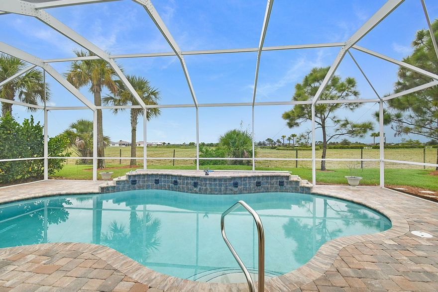 ***SELLER PAYING OFF THE NEXT 18 YEARS OF THE CDD*** New owner will not have one!! Experience the best of 55+ resort-style living in this beautifully designed and very spacious 2-bedroom PLUS den, 2-bath POOL home in the sought-after Del Webb at TRADITION community. This modern residence offers an open and airy floor plan with upgraded finishes, full impact glass windows, volume ceilings throughout, oversized laundry room with upgraded cabinetry, and a covered, screened patio that overlooks a sparkling saltwater pool--set on a preserve, perfect for entertaining or relaxing year-round. The oversized open-concept home features plantation shutters, crown molding, upgraded baseboards, custom built-ins, upgraded countertops and an upgraded extended shower in the owners' suite.  The garage will