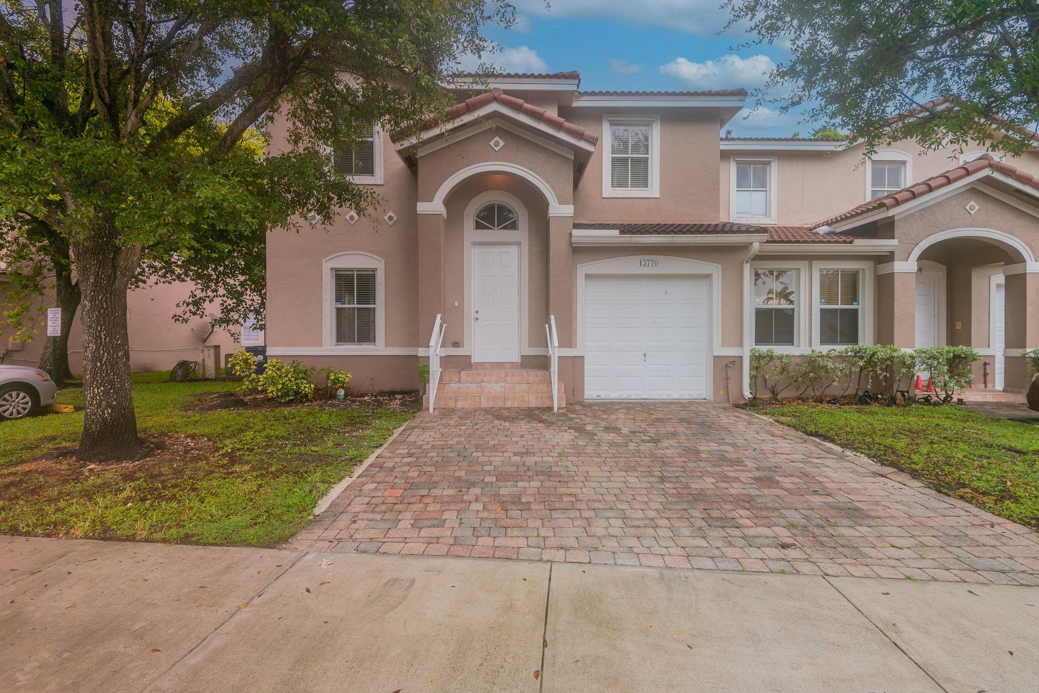 Beautiful two-story townhouse corner unit featuring 4 bedrooms and 2.5 bathrooms. Enjoy a 1-car attached garage and a separate living room perfect for relaxing or entertaining. The kitchen and dining combo includes a convenient kitchen bar and French doors that open to a wood-fenced backyard patio with decorative flooring. The primary bedroom boasts double-door entry, a spacious closet, and a double vanity bathroom for added comfort. This home offers both style and functionality. Schedule a showing today! One or more photos may be virtually staged.