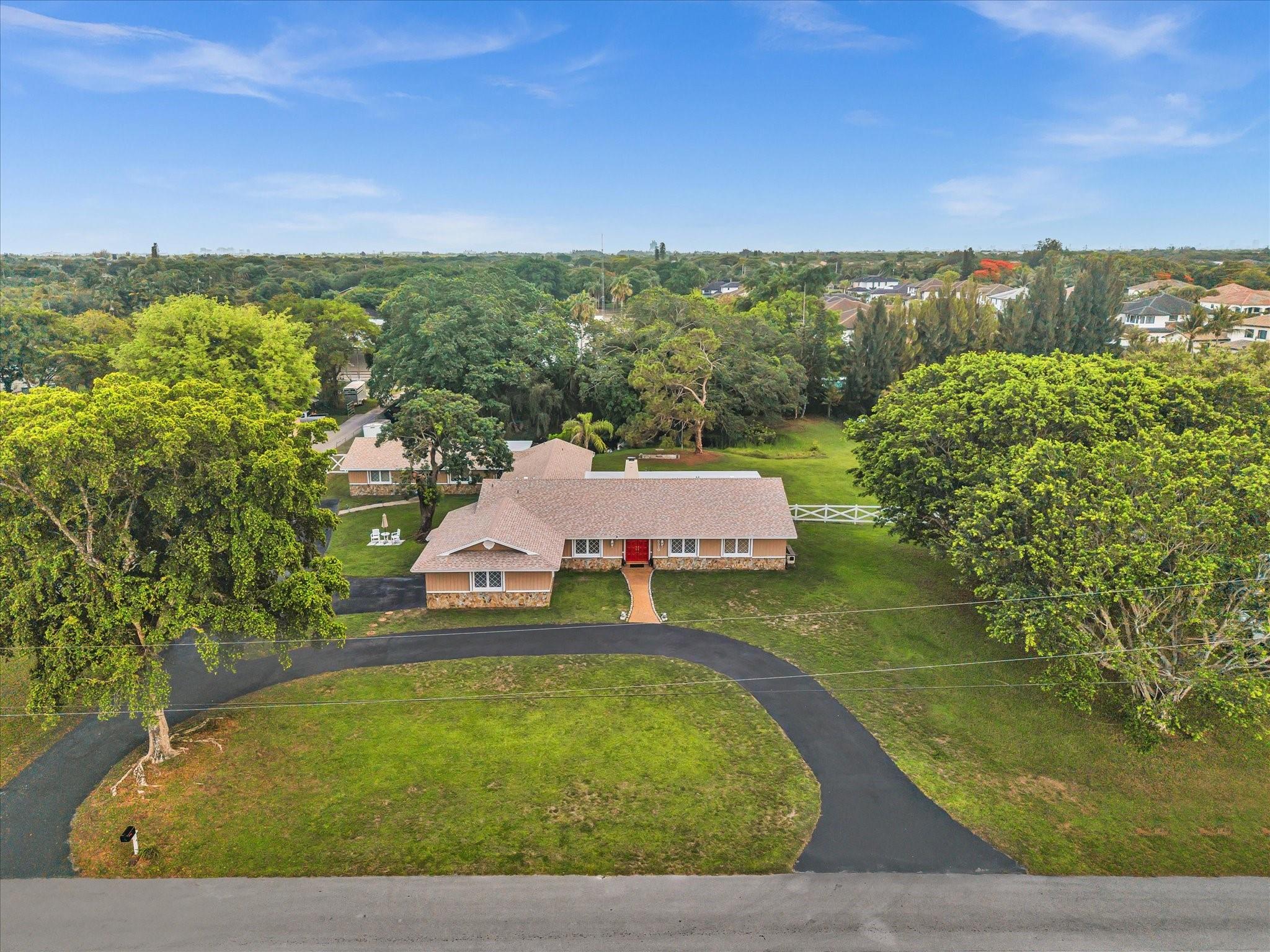 Tucked away on 1.23 acres in the heart of Davie, this estate feels like a private retreat—NO HOA. The main 5BD/2.5BA home features spacious living and a cozy fireplace, perfect for gatherings. Enjoy lush grounds with a tranquil pond, sparkling pool, RV hookup, and ample parking. A separate 2BD/1BA in-law suite (rented month-to-month at $3,000) adds flexibility for guests, extended family, or income. Major updates include a new roof (2025), 2 new AC systems (3T & 5T, 2024), and newer well and pool pumps (pool pump replaced 2025). This one-of-a-kind property blends functionality with charm—ideal for making unforgettable memories. Seller financing available. All information is deemed accurate but to be verified by buyer or their legal representative.