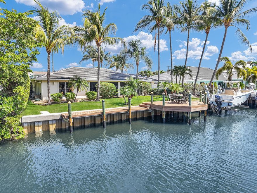 Waterfront Oasis in Boynton Isles!  Experience the epitome of South Florida living in this beautifully maintained waterfront ranch-style home located in the Private Enclave of 7 Luxury & New Waterfront Homes on Kepner Dr.  Boasting 90 feet of canal frontage with no fixed bridges and direct ocean access for World Class Fishing and Diving, this Boaters Dream features a private dock that is equipped with a 15,000 lb boat lift (new seawall, lift and dock in Oct 2019).This spacious 2-bedroom, 2.5-bathroom home offers 1629 sq. ft. under air, with a expansive outdoor Florida room 35' X 11' with wet bar,half bath, sitting and dining area to enjoy the sweeping Waterview and lush garden. Living room and dining room have high ceilings with architectural tray cedar designs. NEW ROOF 2024!   You'll enjoy this functional and updated kitchen with built in oven, microwave, complete with white cabinets, accented with grey countertops and backsplash. Primary Suite includes a walk-in closet and a luxurious bathroom with dual sinks, a separate shower, and a whirlpool tub. Prime Location: Situated on a quiet cul-de-sac east of US-1. NO HOA!