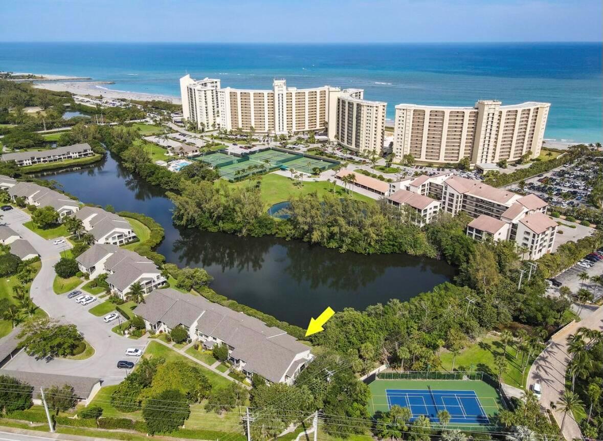 Available for 2026 season $7,500/mo January 1, 2026-April 30, 2026 in Jupiter Dunes. Presenting an exquisite first-floor end unit at Jupiter Dunes, fully renovated to meet modern standards and aesthetics. This home features a wide-open and spacious floor plan, highlighted by a wrap-around patio that offers stunning water views, allowing you to immerse yourself in the true beach lifestyle. Just a short walk away, you can enjoy the sandy shores of the beach and the scenic Inlet Park, perfect for outdoor adventures and relaxation.The property boasts an expansive private patio, providing ample space for entertaining guests or enjoying peaceful moments in the sun.