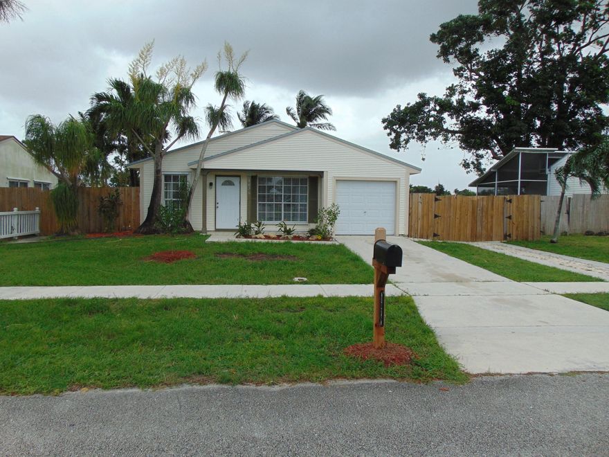 Charming home with many recent updates including new kitchen cabinets, countertops, new carpeting, and fresh paint thru-out.  Home features 3 bedrooms and 2 baths plus a large family room/den off the back of the house that overlooks the large lake no rear neighbors here plus there is a large screen patio overlooking the serene lake great for south Florida casual living.  The master bedroom has ensuite bath with shower and 2 generous closets plus lake views.  The 2nd bedroom is large also looking out on to the lake.  Bedroom 3 is nice size with a nice size closet as well.
Plenty of room for your boat on the paved side drive complete with double wide gate.
Come make this move in ready home yours​​‌​​​​‌​‌​​​‌‌​​​‌‌‌​​‌​​‌‌​​​​ today.