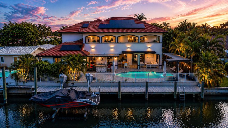 Largest available waterfront home under $2M in Fort Lauderdale! 3,515+ sf living area, 6 bed, 75ft ocean access canal, private dock w/ 10klb boat lift, heated saltwater pool, summer kitchen with gas. Beautiful updated kitchen, double oven, extra outdoor living space. 3 bedrooms on first floor, large primary suite w/ covered patio.  Built in 2011, impact windows and doors, dual zone AC, PVC plumbing, 2 Rinnai tankless water heaters, motorized hurricane screens, smart home and security system. 3 EV chargers and well water irrigation. Located on a quiet dead end street with no through traffic. Oversized driveway, 2 car garage + add'l parking for 8+ vehicles. Located in Coral Ridge Isles, no HOA, close to beach, dining, and shopping. Rare value for a large waterfront home with ocean access.  Solar system installed for improved energy efficiency. Details available upon request.