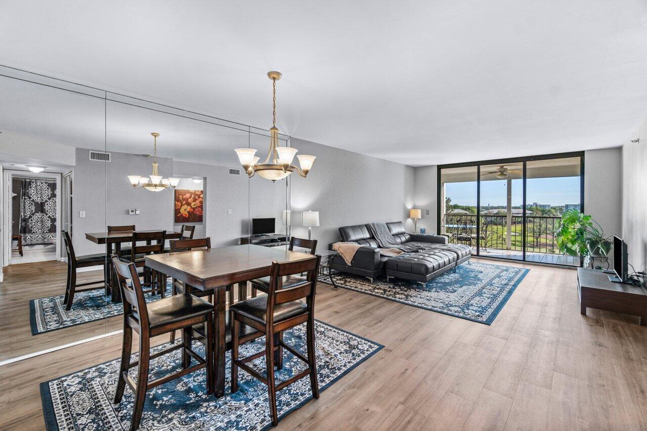 Beautiful penthouse condominium with outstanding golf course and skyline views! Southern exposure. Brand new plank flooring in the living and dining room. Spacious primary suite. New A/C installed in 2022. Full sized washer and dryer. Large screened balcony. Top management operates a fiscally sound community. Fully funded reserves. Milestone inspection and Structural Integrity Reserve Study fully available. Adjacent to the Jack Nicklaus designed Via Mizner Golf & City Club golf course (no membership req). Club Royale is among the best of Central Boca. All homes have beautiful views with southern exposure, covered parking and a separate, private storage room. Newly renovated lobbies and clubhouse with a pool, hot tub, and exercise room. Excellent location. Close to everything.