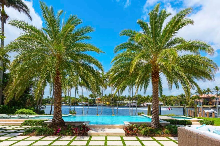 Boasting 161 feet of direct Intracoastal waterfrontage, 1010 Beach Drive invites South Florida luxury living. Nestled between two of East Delray's premier streets with a second entrance on 1031 Seaspray Avenue, the expansive waterfront compound is located blocks from the ocean and Atlantic Avenue's shops and restaurants. Recently renovated, the four-bedroom residence combines a coastal island flair with designer elegance to create a tropical oasis complete with stunning water views and an open floor plan that invites the outdoors in. The spacious covered loggia provides room for outdoor living and entertaining amidst the manicured grounds that perfectly frame the resort-style pool. Boating is a breeze with private dock, lift and nearby inlets. Enjoy serene seaside living at its best! Enjoy all that East Delray Beach has to offer plus easy access to Palm Beach and Boca Raton via A1A. Jetsetters will appreciate the nearby private airports and three international airports. Serious and recreational boaters alike will appreciate the 161 feet of direct Intracoastal waterfrontage with the added benefit of being set back on a basin providing wider unobstructed views with private dock, lift and a short distance to the nearby inlets.

Situated on almost two-thirds of an acre, the waterfront compound can be accessed via Beach Drive and Seaspray Avenue with an expansive pass-through driveway that provides ample parking. The manicured landscape accentuates the home's exterior with a walkway leading to the front porch. The impressive front door with glass feature provides a hint of the exceptional interior and water views that await.

Thanks to a major renovation, the interior enjoys an open floor plan with a coastal palette including hardwood floors, custom molding and high-end finishes throughout. The foyer flows effortlessly to the dining area, living room and covered loggia beyond. The living room has an entire wall of vanishing pocket sliders that invite the outdoors in with the covered loggia continuing to the tropical landscaped grounds, infinity pool and waterway beyond. The spacious chef's kitchen features top-of-the-line appliances including Subzero, Wolf and Thermador; large island with sink and snack bar seating; plenty of cabinets and storage; full-height wine cooler; pass-through door to dining room and a lovely breakfast area overlooking the waterway with a doorway to the covered loggia. 

The bedroom wing is conveniently situated at the north end of the home with each room located off of a generous hallway for maximum privacy. Two of the guest bedrooms have en suite baths and plenty of closet space. The generous master suite is complete with water views, white paneled ceiling, sliding door to pool and grounds, dressing area and completely renovated master bath with marble walls, custom glass walk-in steam shower, double sink vanity and inlay floors. The fourth bedroom could be converted to an office, play room or incorporated into the master suite as a closet. There is a full bath just off the living room and foyer. The laundry room is conveniently located between the kitchen and garage with separate entrances to the front driveway and the pool/outdoor shower. The laundry room has ample storage, a laundry sink and brand new full-sized washer and dryer. The two-car garage is bright with windows and a separate glass door to the backyard and plenty of room for work space and storage. There are three separate attics.

With 161 feet of direct waterfrontage set back from the main waterway, this property offers a rare opportunity for outdoor enjoyment on both land and sea. The covered loggia has plenty of room for outdoor living and dining with porcelain floors that extend out to the poolside terrace. Enjoy endless hours of outdoor entertaining and lounging around the resort-style infinity pool with sun shelf and spa. The tropical grounds include a sandy beach feature with built-in firepit all overlooking the waterway. The private dock has lift and water with electric that can be hooked up. Enjoy day trips along the Intracoastal or venture out on the high seas via nearby Boca Raton and Boynton Beach Inlets.

Major renovations completed in 2015/2016 include new paint in interior and exterior; addition of pool with Smart controls; hardwood floors installed; updated kitchen, laundry room with half bath, and master suite; covered loggia and outdoor living area with porcelain floor, awnings and cooking area with gas stub; custom cabinetry; impact windows with the exception of front door and dining area bay window; electrical updates including LED lighting; non-wood decking at dock; new zoned irrigation and landscape with raised grade/elevation throughout, gas firepit and pavers with synthetic turf spines at pool; new gutters and downspouts; new impact resistant garage door; and new paver walk ways.

The East Delray Beach compound provides privacy for tranquil retreats and plenty of room to entertain or take a golf cart ride to the nearby beach, shops and restaurants. The waterfront property located at 1010 Beach Drive is the perfect destination for enjoying South Florida Luxury Living.