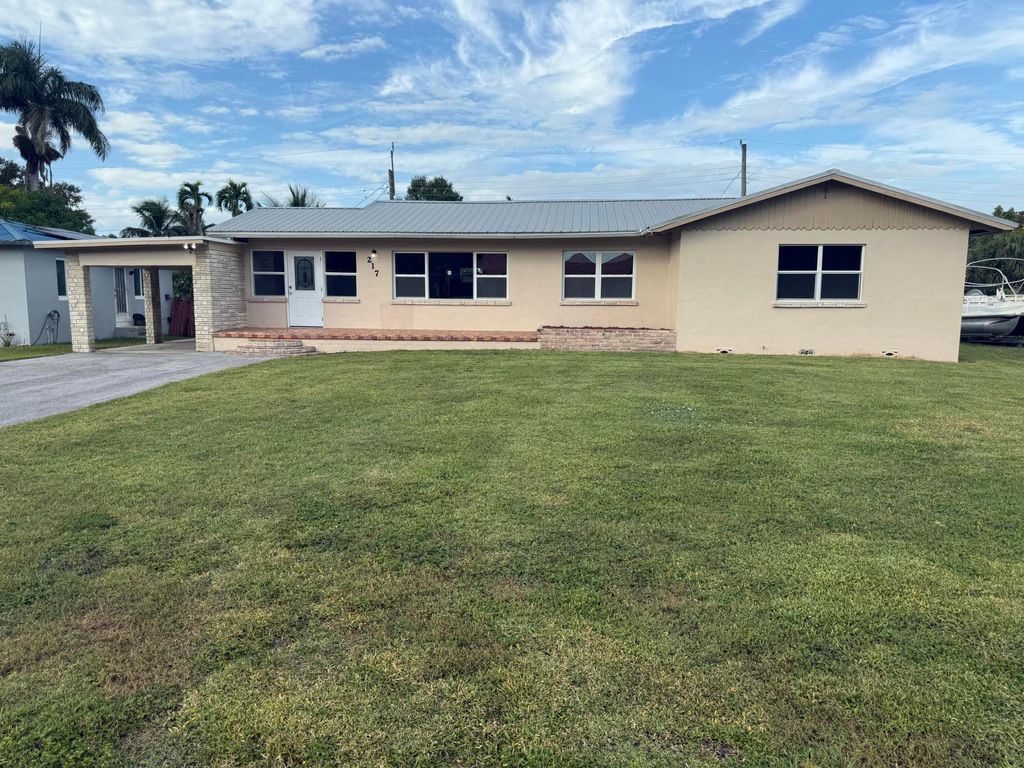 Photo of 217 NW Avenue Ave E, Belle Glade, FL 33430 (MLS # R11138397)