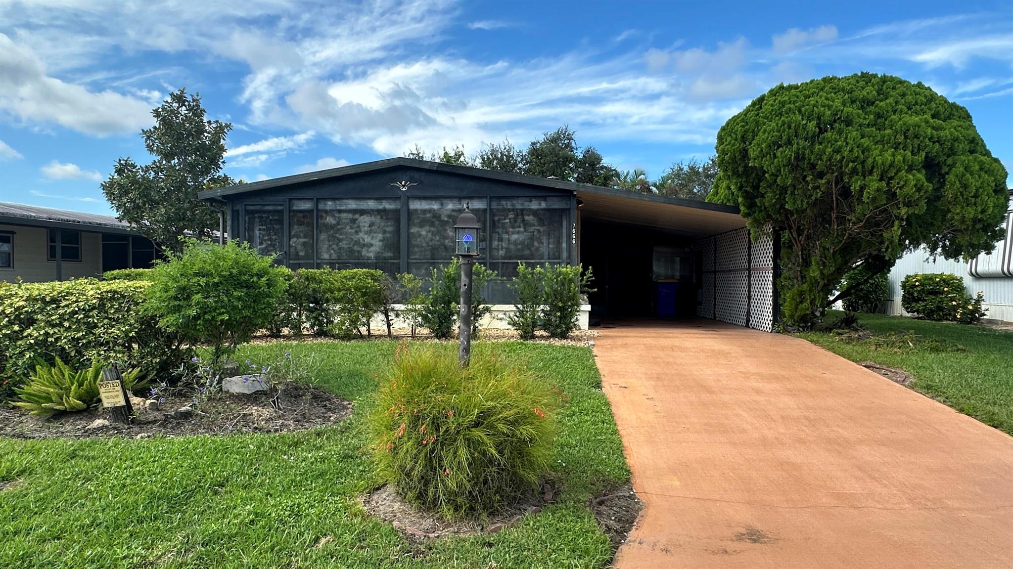 Lovely 2 Bedrm/2 Bath Manuf home in Cambridge 55+ community in Hobe Sound. REAL WOODBURNING FIREPLACE for occasional chilly nights. 1254 SF under A/C w 2 ADDITIONAL SCREEN ROOMS for your pleasure w roll down shutters! 2023 New Flooring in Kitchen, dining room & Primary Bedrm & bath. The Living Room is very large (13X23) w the formal Dining Room adjacent. The Kitchen is also large with newer Stainless appliances. The Primary Bedroom is large w so much storage. Primary bathroom has dual sinks, make up vanity, walk in closet & 2 additional closets & step in shower. The 2nd Bedrm is a good side w a walk in closet & full bath on the hall. The Front Lanai faces east for the morning sun & those famous Hobe Sound Breezes. YOU OWN THE LAND - ALL PETS WELCOME. 2017 3 TON A/C - 2005 AMS Aluminum Ro