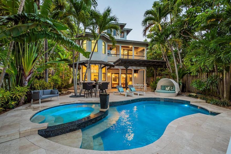 Directly on Middle River in desirable Bayview School District! Key West architecture crowned w/ two cupolas inviting natural light throughout. Gated estate surrounded by tropical vegetation. Enjoy spectacular sunsets and entertaining.