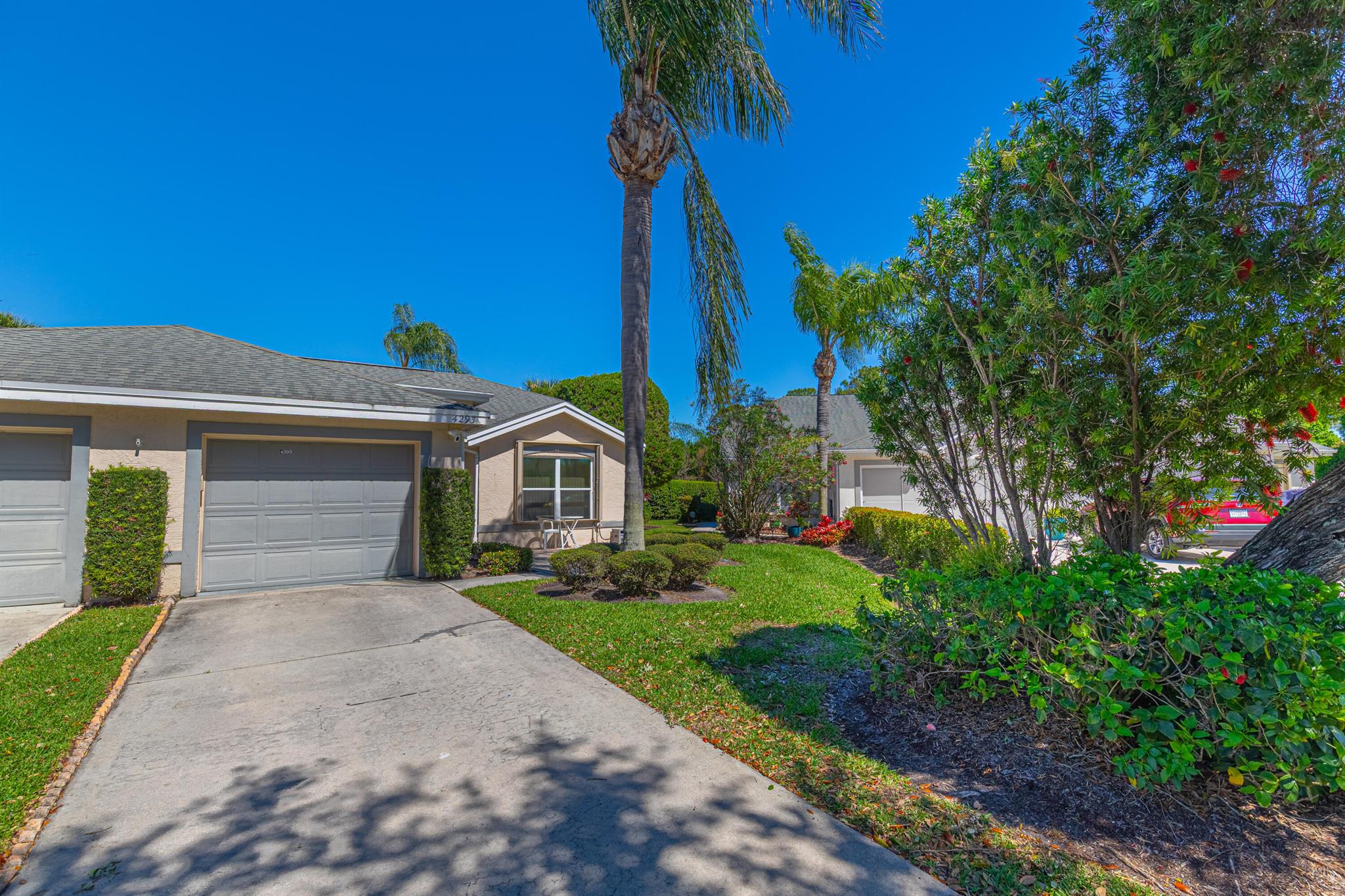 Nestled within the prestigious Garden of St. Lucie community, this exquisitely renovated 2-bedroom, 2-bath corner unit offers modern upgrades throughout. Step inside to discover soaring vaulted ceilings, Wood Floor throughout, freshly painted interior and exterior, elegant crown molding, and stylish new fixtures. The expansive open kitchen is designed for both functionality and entertaining, featuring stunning marble countertops, backsplash, custom wood cabinets, and high-end appliances. The spacious primary suite boasts a large walk-in closet and a fully renovated en-suite bathroom with marble countertops and wood cabinetry. Additional updates include a new A/C and water heater (2024), Roof (2022), and a brand-new roof over the lanai (2025).