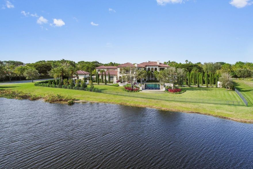 Located on 2.5 acres in the exclusive Stone Creek Ranch community, this magnificent estate sits on exquisitely landscaped grounds with sweeping lakefront views. Designed in a modern Metropolitan style, this eight-bedroom home features casual elegance that invites both private living and festive entertaining. Stone and grass terraces surround the 25'x 50' infinity pool and spa, with reflective pools flanking each side. Enjoy outdoor living with a covered loggia, fireplace, lounge, dining area and full summer kitchen. The double-gated circular entrance leads to the seven bay garage and private tennis court. Other features include a chef's kitchen, wine room, gym, 9-person theater, custom designed office, game room loft and full house generator. The smart home operates on a control 4 system. Created to exude a casual metropolitan elegance, this five-star estate enjoys picturesque lake views throughout. The two-story residence offers eight bedrooms; seven full and two half baths; 9,974 square feet under air; and 14,724 total square feet. Every room in the house reflects the custom finishes and intricate detail including wood-and-marble flooring, arches throughout, marble countertops and customized lighting. The interior spaces have oversized windows to allow for natural light and endless water views. 

The impressive home is graced with sensational curb appeal. The magnificent grounds beautifully frame the double-gated circular drive, with ample parking, in addition to the side-entry seven-bay garage, and north-south tennis court.  As you enter the house, the grand foyer leads into the 27' arched window-walled two-story living room, with its spectacular view of the infinity pool that seems to flow right into the lake. The massive paneled wall, in the living room houses a linear fireplace that adds warmth to the voluminous room. The rich wood, contrasting with the cream porcelain, ties the space back to the wood-and-marble flooring in the nearby entry and hallway. 

Arches continue as a theme to the formal dining room, with French doors overlooking a garden and fountain. The Chef's Kitchen is outfitted with a gas Wolf cook-top with a vented hood, side by side Subzero fridge & freezer, Wolf double ovens, Wolf microwave, pair of Asko dishwashers and built in Miele coffee maker. The octagonal breakfast bay and family room, with a wall of doors that open completely, face over the lush lakefront grounds. Also featuring a 9-person theater with tiered seating, opulent wine room, gym and custom designed office. The lakeside master suite and marble bath are adjacent to a private loggia. The guest suite and two powder rooms complete the first floor. 

The decorative staircase beautifully curves leading to the gallery bridge, which separates the east and west wings, and overlooks the living room below and stunning property views. The loft, currently used as a game and billiards room, leads out to a magnificent loggia with a fireplace and breathtaking lake and property views. The second level also features four en suite bedrooms including two that face the lake and one with a private loggia, for relaxing and taking in the magnificent lake views. 

Enjoy endless hours of outdoor entertainment with numerous covered and open spaces for lounging and a summer kitchen with grill for al fresco dining. The magnificent large heated infinity pool is the perfect spot to enjoy sun and fun. 

The separate guesthouse has a private entrance or connects through the house and features a living room, full kitchen, two bedrooms and bath.

The landscaping boasts the feeling of a villa in Italy, including reflecting pools and fountains in the garden. The back of the house has a sitting garden and other rest areas that take in views of the water and the entire length of the property. In contrast, the front of the house was designed with privacy in mind. This 5-star waterfront estate is the quintessential luxury residence. 


For all FEATURES and FLOOR PLANS, please view DOCUMENTS