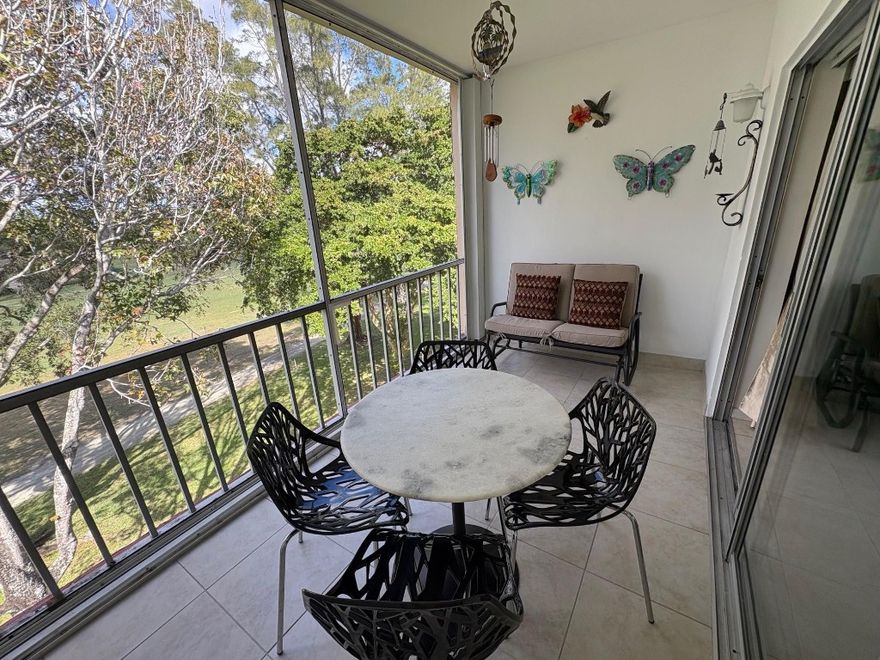 Beautiful spacious split plan 2 bedroom, 2 full bath condo with view of the golf course. Recessed lighting in the kitchen, new bathroom vanities & gorgeous lighting upgrades. 18 inch tile throughout the unit. Bedrooms have high end wood flooring. Hurricane impact windows, fantastic breezy screened porch. Many amenities; 2 heated pools, clubhouse, billiard room, gym & library. 4 golf ranges; Driving, Chipping, Putting and 18 hole course AND a golf clubhouse with an active and fun lounge and golf store. Cable included in condo fees. Pick up trucks and motor cycles allowed. 50 year certification passed. Can rent after one year. Unit building is walking distance to all of the golf activities. Credit score of 725 or above. 40K minimum income. Fantastic fun community! A youthful 55+ atmosphere.