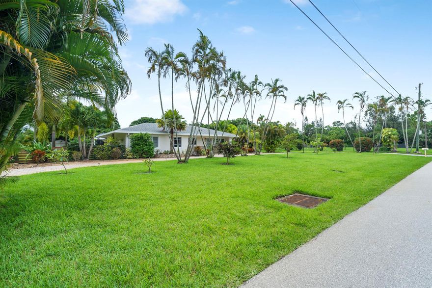 This updated open floor plan home features modern cabinetry, quartz countertops, stainless steel appliances, premium ceiling fans and lighting, a skylight, four sun tunnels, two custom fireplaces, TVs, and ample storage. Outside, there's a saltwater pool and a full outdoor kitchen with a BBQ grill. Set on over 2.3 acres with 100+ fruit trees, it's ideal for entertaining.