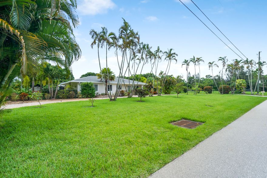This updated open floor plan home features modern cabinetry, quartz countertops, stainless steel appliances, premium ceiling fans and lighting, a skylight, four sun tunnels, two custom fireplaces, TVs, and ample storage. Outside, there's a saltwater pool and a full outdoor kitchen with a BBQ grill. Set on over 2.3 acres with 100+ fruit trees, it's ideal for entertaining.