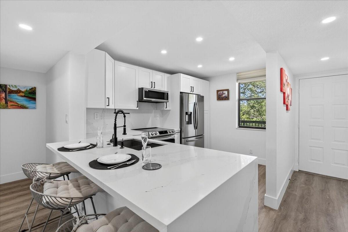 Don’t miss this beautifully renovated condo offering updates and finishes not found at this price point. Pride of ownership, combined with impeccable taste, prevails.   Renovations started in 2022 and were completed in 2024. This condo, with 1,300 sq ft of living space, offers 2 Bedrooms, 2 Bathrooms, a modern kitchen featuring a Waterfall Quartz countertop, High-End Stainless Appliances, and recessed lighting throughout. Bathrooms have been updated, adding to the condo's elegance. Plenty of closet space and a spacious laundry room.  Make this your starting or ending home, where you’ll have daily breathtaking views from your living room Wall to Wall window overlooking a peaceful waterway with an unobstructed view of a nature preserve