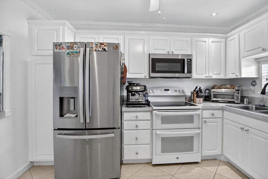 Beautiful Two-Bedroom Condo with Panoramic Lake and Golf Course ViewsLocated in the highly sought-after Phase 1 community, this spacious full two-bedroom residence offers breathtaking long lake views overlooking the PGA golf course. The kitchen has been tastefully updated with a new refrigerator and double-oven stove. Washer and dryer outlets are permitted and conveniently installed in the master closet. The home features mostly tile flooring, with brand-new laminate floors in the bedrooms. Master bedroom windows are impact-rated, and the glass sliding door is equipped with a hurricane code shutter. The enclosed terrace, complete with screens and windows, provides additional living space to enjoy the serene water views.