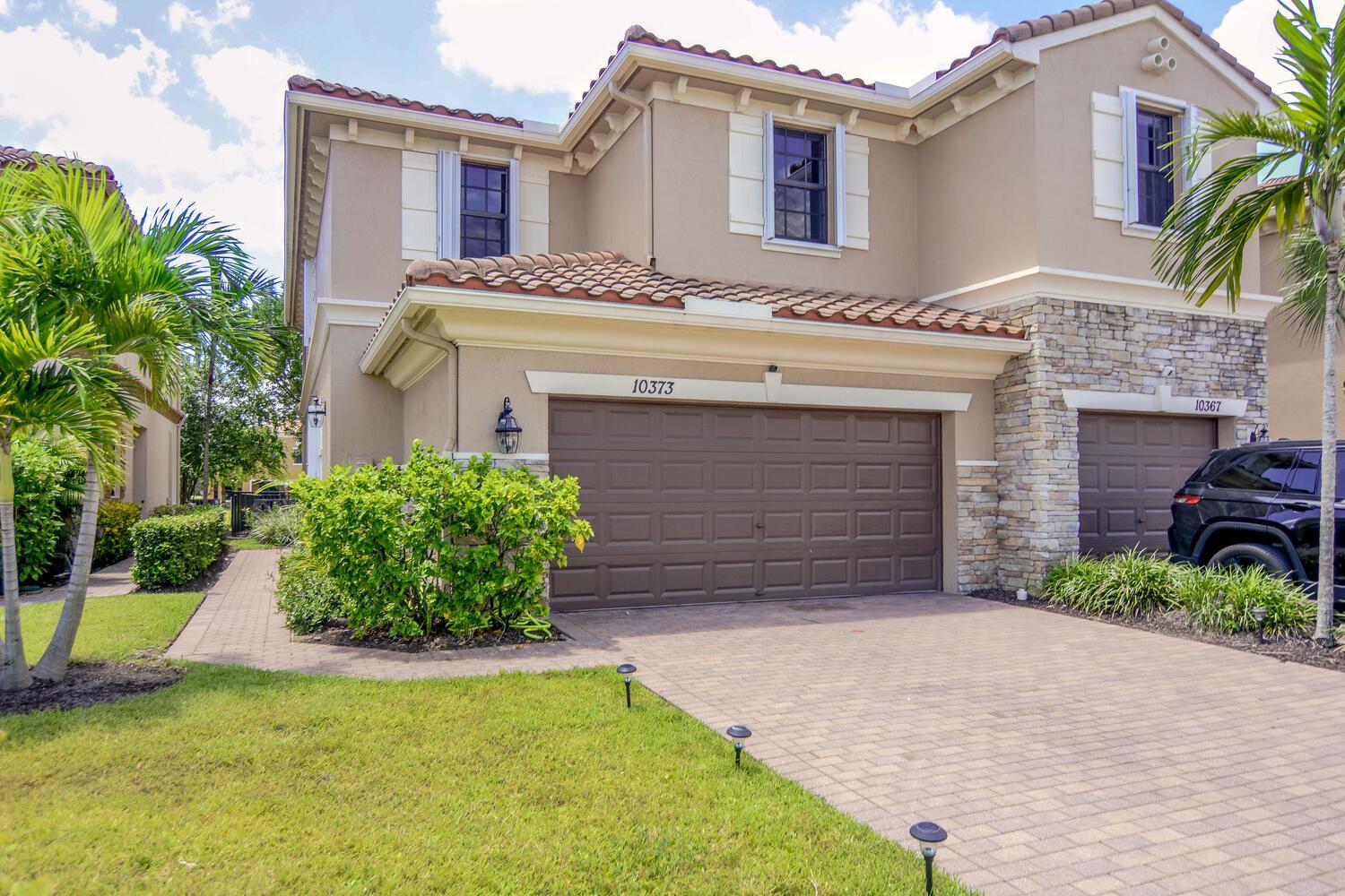 Stunning Corner Townhome in Desirable Wellington Parc!Welcome to this spacious 4-bedroom, 3-bathroom two-story townhome with a 2-car garage, located in the sought-after Wellington Parc community. Built in 2014, this beautifully upgraded home offers the perfect blend of comfort, style, and functionality.Step inside to find ceramic tile and laminate flooring throughout, a gourmet kitchen featuring granite countertops, dark wood cabinetry, and stainless steel appliances. The open layout includes a convenient first-floor bedroom and full bathroom, perfect for guests or multi-generational living.Upstairs, the luxurious master suite boasts walk-in closets and an elegant en-suite bathroom with a Roman tub, separate shower, and dual sinks. Enjoy tranquil mornings and evenings