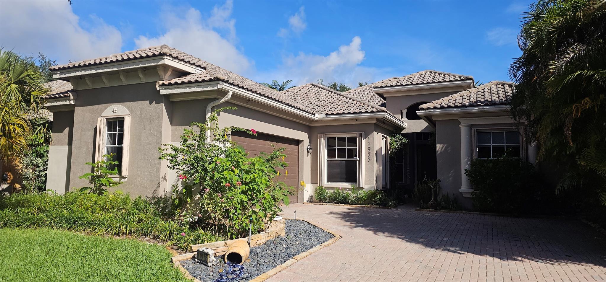 Step into this stunning 6-bedroom, 3-bathroom Ashton model home in the prestigious, guard-gated community of Heron Bay. Perfectly designed for a large family, this spacious, triple-split floor plan features ensuite for guests or an au pair. The home's elegant interior boasts volume ceilings, crown molding, and an open-concept kitchen with granite countertops and stainless steel appliances. Outside, your private, fenced-in tropical oasis awaits with low-maintenance AstroTurf and a lush, meticulously curated landscape of rare and native plants that attract hummingbirds and butterflies. Enjoy fresh mangoes. The large master suite offers separate shower and tub. The community features state of the art pool, fitness center and club house with 24 hour guard gate. Accordion Shutters throughout.