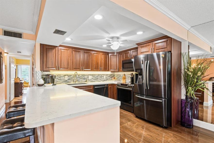 Spectacular opportunity to own this wonderfully renovated top floor unit in Century Village, West Palm Beach's best kept secret.  This spacious 2/2, updated in 2017, has front impact windows, a newer luxurious open concept kitchen with stylish quartz counter tops, soft close cabinets, purified drinking water, newer Samsung stainless steel appliances, newer baseboards, porcelain tile and marble flooring, newer comfort level custom bathroom vanities all with a stunning lake view. 

6 community heated pools pools, pickle ball, clubhouse, tennis, bocce ball, theater (plays and concerts) events, movies, water aerobics, shuffle board, arts and crafts and more..  See it by virtual tour and then schedule your private showing