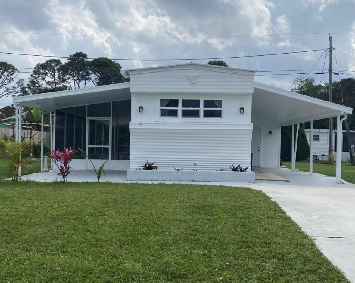 Look no further than this hidden gem located in Stuart in a quiet residential community. NO HOA Fees, you own the land. Perfect for an investment property, snowbirds or AIR BNB potential. The entire home has been renovated with a new Electrical system, new insulation, new Plumbing throughout with new Water Filtration system, pump and heater. Custom carpentry featuring white custom cabinetry, quartz countertops, island with stainless steel sink, marble back splash and new stainless steel appliances. A new bathroom with a large vanity, private half bathroom, along with extra closet space, high quality vinyl waterproof flooring throughout, and freshly painted. Large screened in patio and two covered porches, ideal for entertaining. Large storage space with washer/dryer hookup, workshop/shed