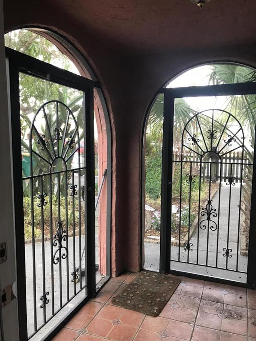 Great Spanish style frame stucco(aluminum sided) home w/ fireplace on double lot. Remodeled kitchen and bath. Inside washer and dryer. Plenty of room for RV parking.Rolling gates in front and back. 5 different storage sheds on property. Alley access for parking multiple cars. 2 Bedroom home but front office could be 3rd bedroom(No closet). 2 different patio areas with paver bricks.Fruit trees provide shade for cooler living.Custom tile at entrance.Sliding doors off kitchen lead to screened porch. Great area to enjoy outdoor dining.High capacity tankless water heater.Windows have aluminum clamshell storm protection.Short walk to downtown.