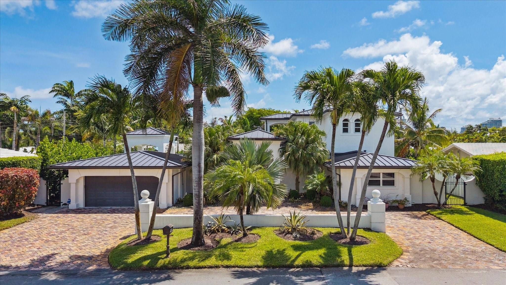 Coral Ridge luxury home in Bayview School District. Expertly renovated in 2021, this 3,011 sq ft, 3 bed, 3.5 bath residence features a metal roof, impact windows/doors, and an open-concept chef’s kitchen with Sub-Zero & Miele appliances, custom cabinetry, and oversized island. Two large first-floor ensuite bedrooms offer flexibility for guests or multi-generational living. The private upstairs primary suite includes a spa-style bath, walk-in closet, and covered balcony. Outdoor living boasts a heated saltwater pool, dining patio, and 4-hole putting green. Minutes to Fort Lauderdale Beach, shopping, dining, and parks.
