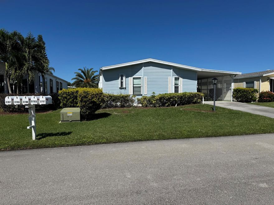 OWN YOUR OWN LAND!!!!   This is a great location close to the Clubhouse, Golf Course and Tennis Courts.  Two bedroom, two bath, with luxury vinyl flooring in bedrooms and kitchen and carpet in living and dining.  There also is a Florida Room, accordion shutters, storage shed, and carport. Resort-style amenities include an onsite restaurant, tennis, pickleball, golf, 3 pools, fitness center, 2 clubhouses, 10,000 sf theater, and lots of other amenities. It is priced to sell quickly.  Don't miss this great opportunity.