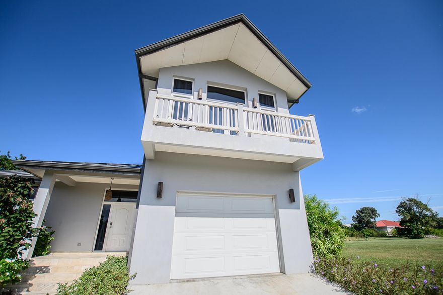 Located in the sought-after Savannah Homes community in Hopkins, Belize, this beautifully built 3BR/3BA solid concrete home offers open-concept living, central A/C, and lush landscaped grounds. Enjoy resort-style amenities with access to Jaguar Reef's beach, pool, and clubhouse just across the street. Ideal as a primary residence, vacation home, or income-producing rental. Adjacent lot available for purchase separately.