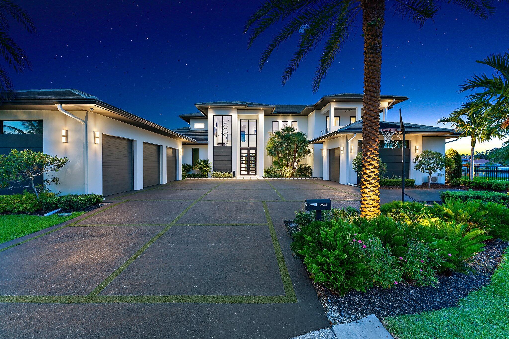 Discover unparalleled luxury in this one of a kind waterfront estate, ideally situated on a rare point lot in the exclusive, gated community of the Islands of Jupiter. This opulent residence boasts 5 spacious bedrooms and 6.5 elegantly appointed bathrooms, including a separate guest quarter. The architectural contemporary design features floating interior walls and flush wall doors, creating a sleek and modern aesthetic. The expansive living space is perfect for both grand entertaining and intimate family living. Each generously sized bedroom offers a private retreat with elegant finishes, while the spa-like bathrooms include a lavish ground floor master suite with a steam room for ultimate relaxation. The second floor includes three bedroom additional laundry, and an expansive loft.