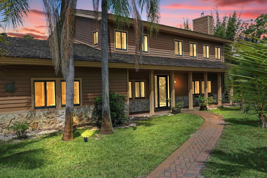 This Is It -Tranquility meets Location in Jensen Beach! Welcome to this stunning steel beam constructed home in Sugarhill, one of Martin County's most prestigious neighborhoods. Perfectly positioned on a private 1.1-acre lot bordering a wildlife preserve, this property offers the best of privacy, nature, and convenience. The home offers 4 Bedrooms plus den, 2.5 Bathrooms and 3-Car Garage. Also, the property features a spacious living room with a charming stone fireplace. The bright dining area is adjacent to and an open-concept family room/kitchen. Kitchen offers granite countertops & stainless steel appliances. Impact glass doors open to a screened lanai and pool, perfect for year-round enjoyment.  Impact-rated newer doors and windows were added for security.  This home is a must see!