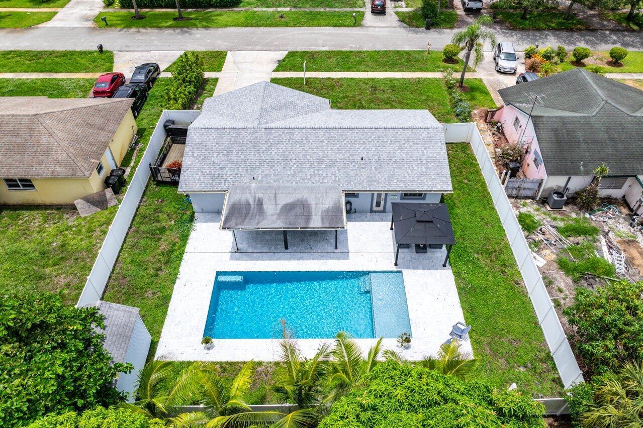 Meticulously re-imagined, designer-finished 2BR/2BA home just 5 minutes from vibrant Atlantic Ave's dining, shops, and beach. Thoughtfully curated layout offers exceptional flow and generous room sizes, walk-in primary closet, smart and open kitchen with island and lots of counterspace, vegetable prep sink, and oversized pantry. Modern baths feature floor-to-ceiling tile with modern and attractive finishes. All-impact glass, 2022 roof, LED ceiling lighting, fully privatized backyard with PVC fencing, a new saltwater pool with sun shelf, marble patio, and covered outdoor space. Landscaped yard with gazebo and large shed make this a perfect outdoor entertainment destination. Garage features a professional epoxy floor, utility sink in laundry. All closets built out. Everything is newly done.