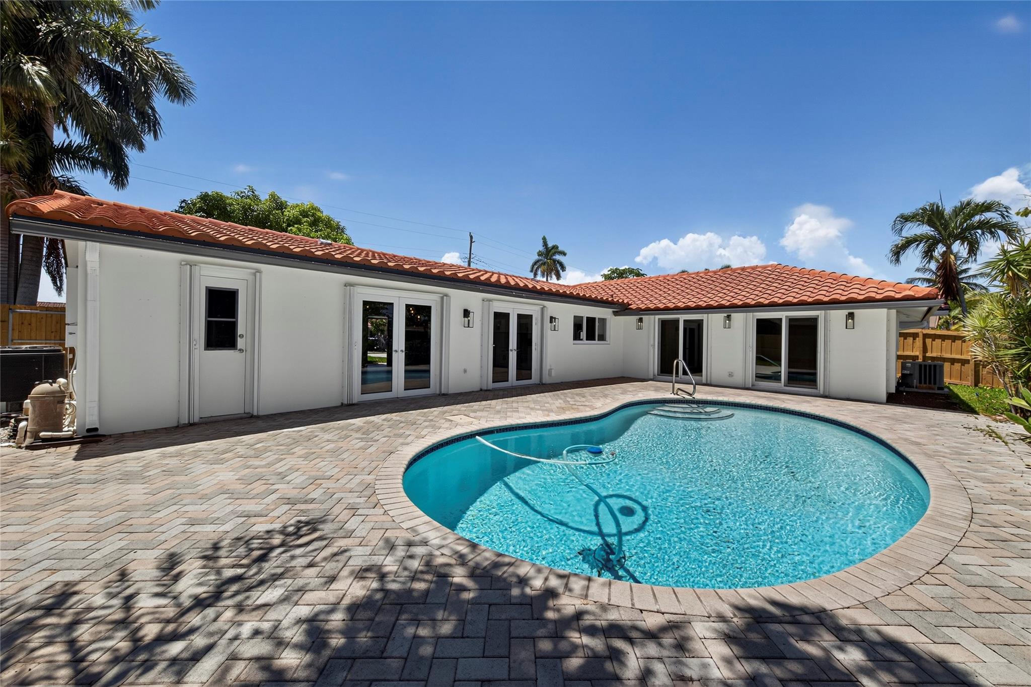 No expense was spared in COMPLETELY renovating this 3 bedroom, 3 bathroom home, all of which was fully PERMITTED and inspected. An ocean-access dock and a 2-car garage complete all of the checked boxes. ALL new kitchen with quartz counters and upgraded new stainless appliances. BEAUTIFUL all new 24x48 porcelain tile floors throughout. ALL new 3 full bathrooms, one of which is a cabana bath. SPACIOUS master bedroom with high ceilings, HUGE walk-in closet and roomy master bathoom completely removed from the guest suites. All new lighting and ceiling fans. This home offers a LOT of natural lighting and a beautiful pool area that's on the water. This home is 100% turnkey and 100% hurricane ready as well! Full 2 car garage and double driveway for ample parking. TRULY a must see!