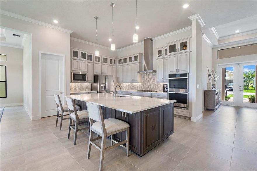 Magnificent Completely Upgraded 3/3.5 Waterfront Home In The Falls at Parkland, YOU won't find a Better Priced Home in the Community + there is NO 18 months Waiting List To Build, You can MOVE right in. Waterfront Lot with Many Features Inside the Home Like Open Floor Plan, Spacious Living area, 12' Ceiling w/ Molding. Over 2,600 Sq, Upgrades Like: Gourmet Kitchen w/ Dble Stacked Cabinets, Extended Kitchen Island, GE Profile SS Appliances, Natural Gas Stove, Large Pantry, Smart Home Security, Glass Front Door, Foyer, Full Impact windows & doors. Lanie Patio, Porcelain Tile. Master Features Large Closet, Dual Vanities, Panel Glass Shower. Split Layout. Lrg Laundry Room, Garage w/ Epoxy Flooring. Guard Gated, resort Style Amenities, Incl. Clubhouse, Pickleball, Pool. 55+ Living At Its Finest