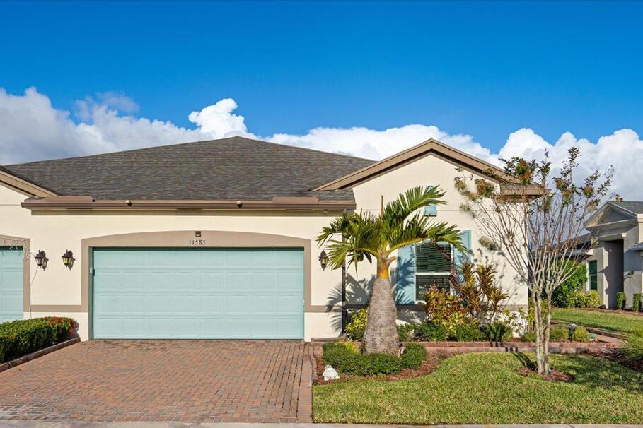 Gorgeous Banyan model in LakePark, a premiere 55+ community in Tradition. This CBS paired villa offers 2BR, 2BA + Den & 2CG with 1735sf of flexible living space. Interior features impact windows, central vacuum, wood-plank tile flooring throughout and the upgraded kitchen option. 42'' white shaker cabinets and drawers, light quartz counters and S/S appliances. Primary Suite has generous en-suite bathroom with dual sinks and separate shower. Large separate laundry/utility room and extended garage with 8' of additonal storage space. Enjoy the FL sunshine on covered and screened lanai or head out to the extended paver patio with adjacent lake views and privacy hedges. HOA includes Lawn Care, Ext Pest Control, Cable, Hi-Speed Internet, Home Phone, Alarm Monitoring and so much more!