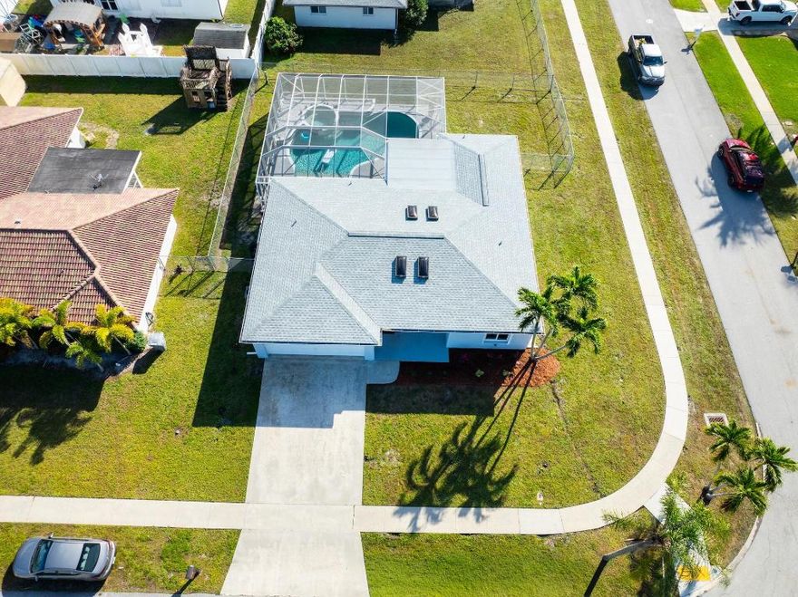 Beautiful and inviting 3-bedroom, 2-bath home with a 2-car garage, located in desirable Palmetto Pines of Boca Raton. Situated on an oversized corner lot, this home features a large screened-in heated pool & spa, perfect for year-round outdoor living. Complete hurricane-impact windows and a new roof, both completed in 2024. The primary suite boasts a walk-in closet and a beautifully renovated bathroom with direct access to the pool area. Luxury vinyl flooring throughout the home while custom lighting and skylights enhance the living spaces with abundant natural light. The spacious eat-in kitchen includes a breakfast area ideal for casual dining & entertaining. A-rated school district and just minutes from Boca's premier shopping, dining, & amenities. Low HOA of only $41.67 p/month.