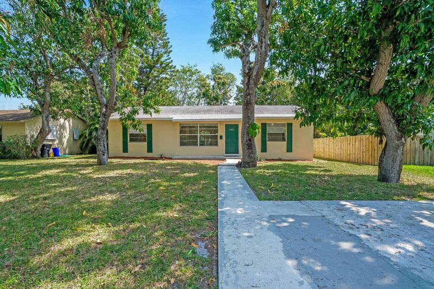 Minutes from Palm Beach's beaches and downtown, this quiet, charming home offers a huge fenced yard, brand-new roof, and fully updated kitchen and baths. This concrete-block, split-floor-plan home features three spacious bedrooms, two baths, inside laundry, and convenient driveway parking. Lawn care may be included—move-in ready!