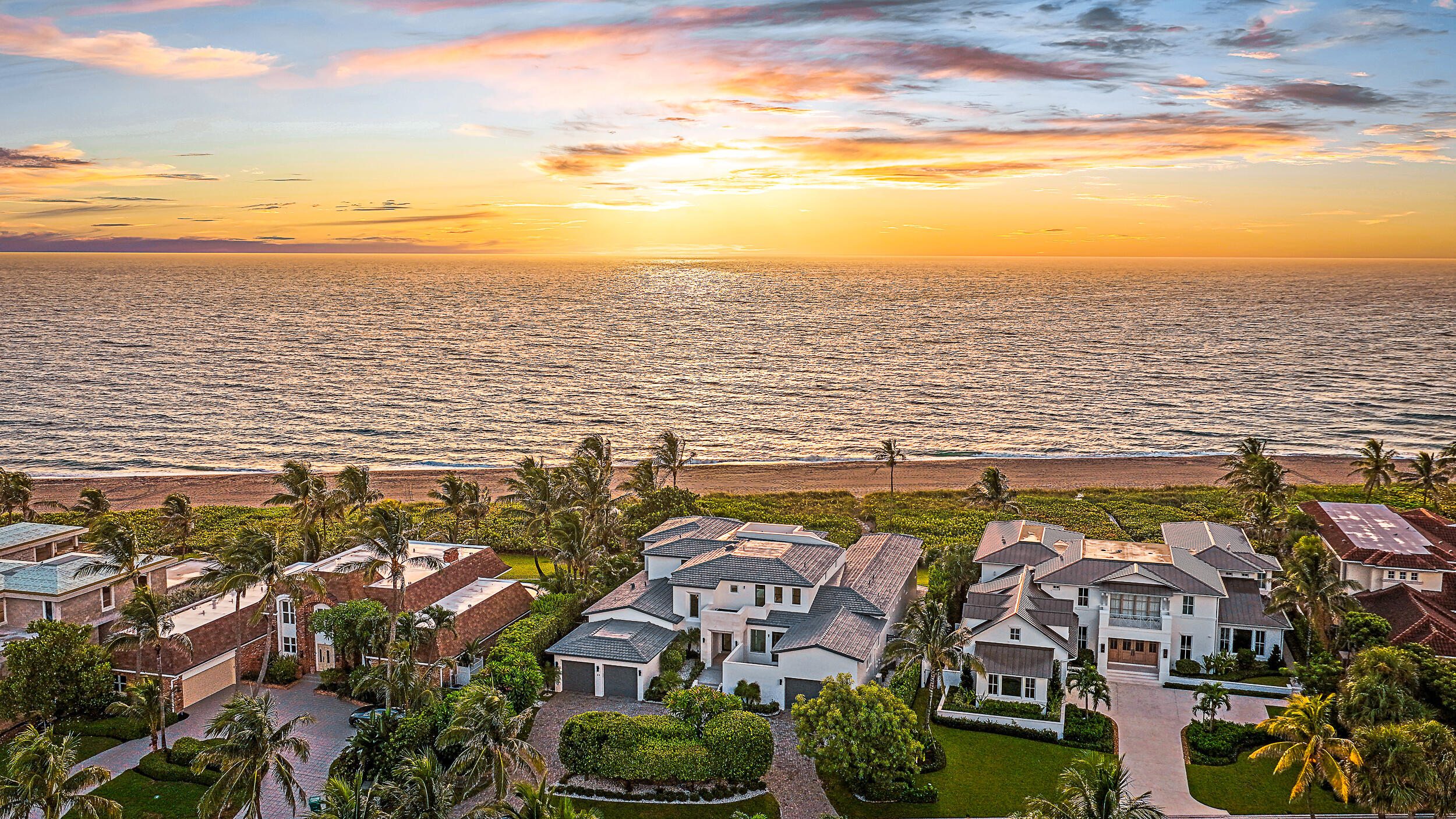 RENOVATION & ADDITION COMPLETE - Ocean views greet you the moment you approach the new pivot front door, drawing your eye through expansive impact-rated sliders and windows that flood the interior with natural light. And the views don't stop there, ascend to the rooftop viewing deck for panoramic views of the Atlantic Ocean, the iconic Jupiter Lighthouse, and the Jupiter Inlet. With approximately 100 feet of prime beachfront, and fewer than 25 direct oceanfront homes in Jupiter Inlet Colony, this is a rare opportunity to own a true piece of paradise. Situated in one of South Florida's most exclusive seaside communities, this residence offers the ultimate coastal lifestyle with deeded beach access, a private beach club, and its own dedicated police department for